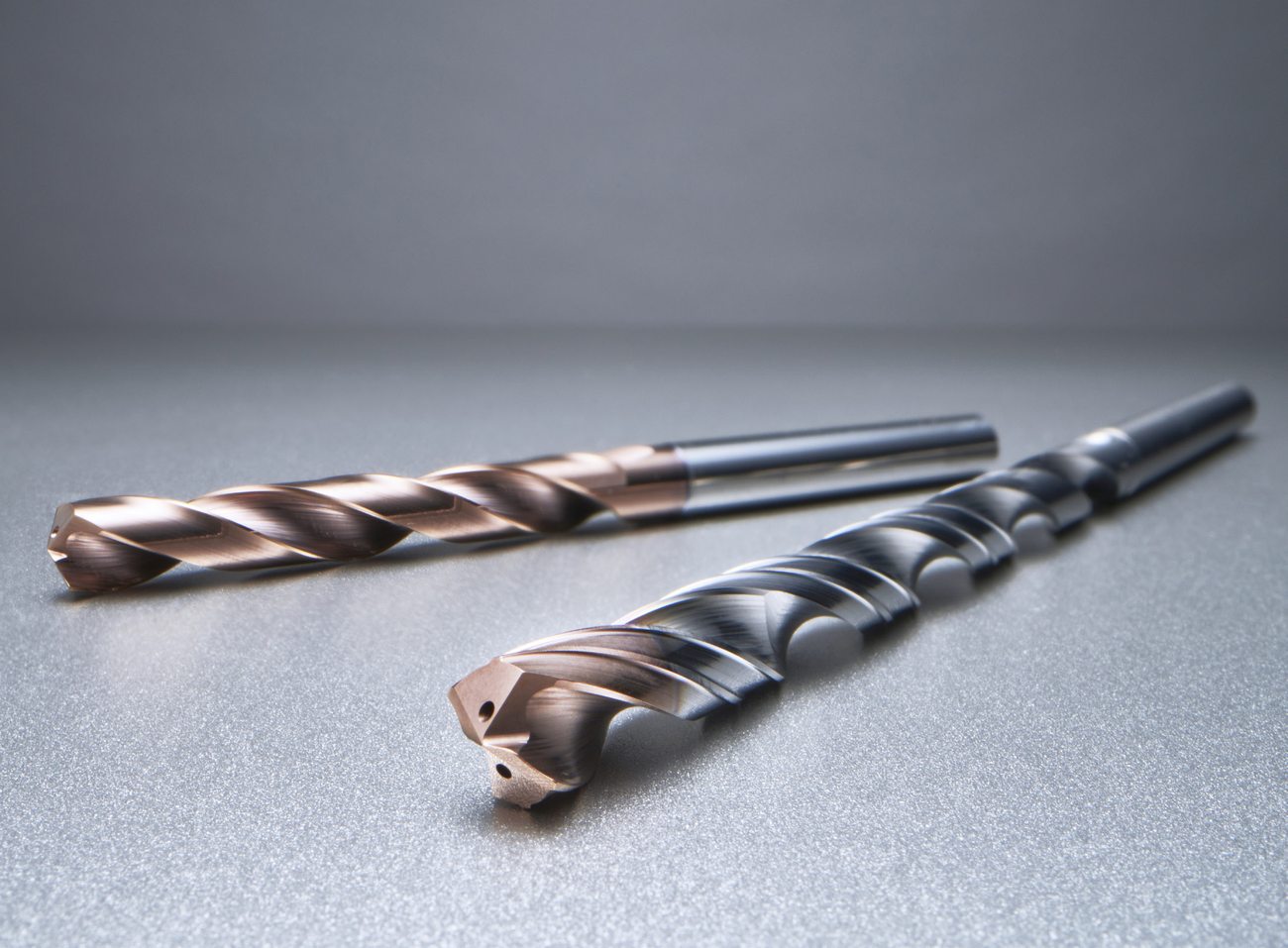 Korloy MSD Plus-S solid-carbide through-coolant drills for Inconel and titanium, showing the PC325T-coated fluted body and 140-degree drill point