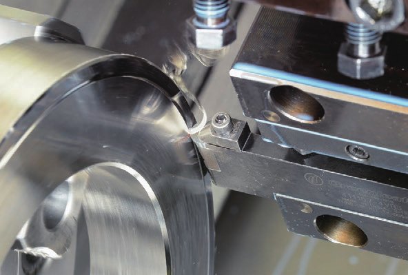 NTK BIDEMICS grade turning an aerospace nickel-superalloy ring on a lathe