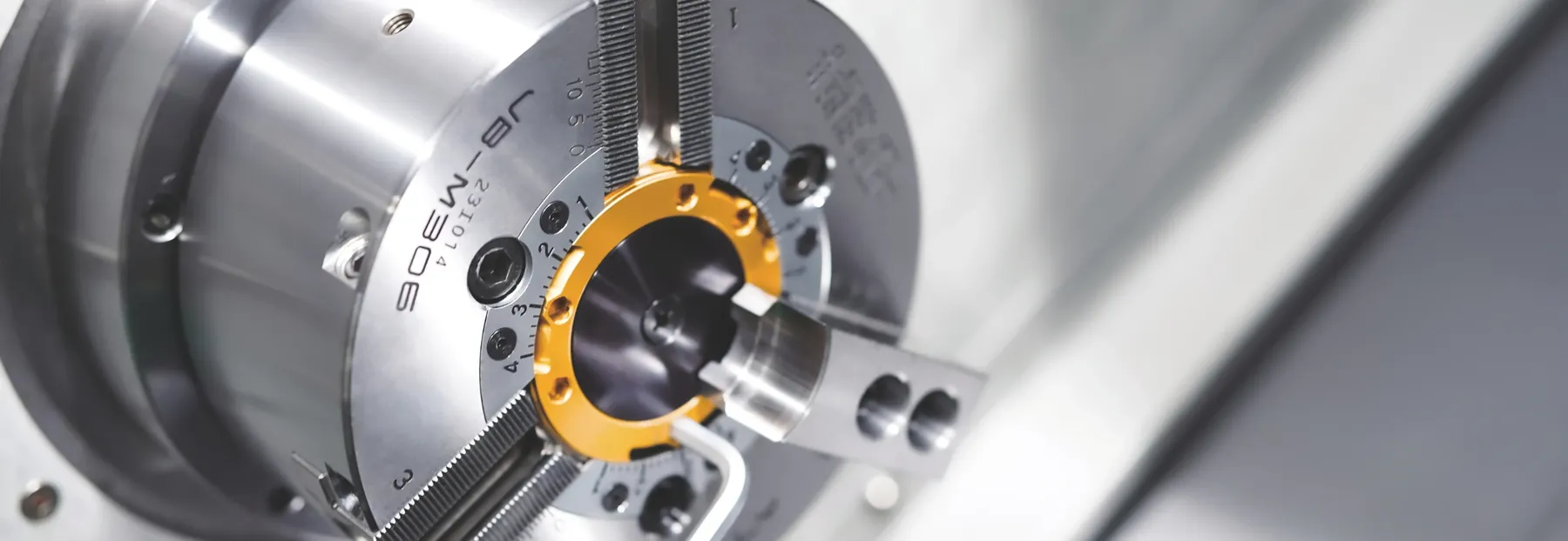 Samchully JB-M306 power chuck with its built-in jaw boring ring set on the spindle, soft jaws gripping a boring plug