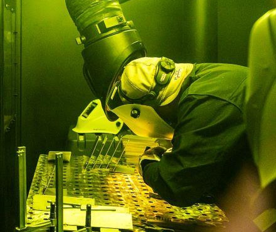 Welder joining a fixtured assembly at the bench